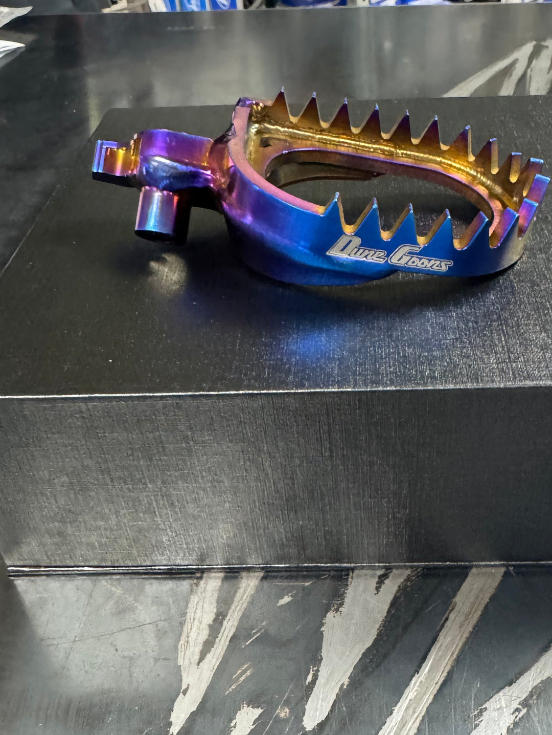 Dune Goons titanium foot pegs in blue anodized finish for Yamaha YZF, side view with Dune Goons logo